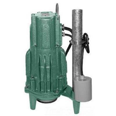 Green Zoeller grinder pump with gray discharge pipe and black valve handle on white background.