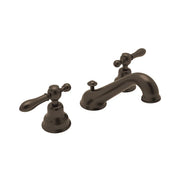 Three-piece widespread bathroom faucet in tuscan brass with lever handles and curved C-spout.