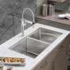 Stainless steel dual bowl sink with single faucet and drain in countertop installation.