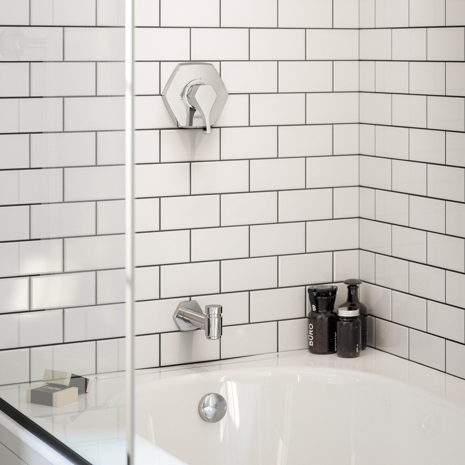 Chrome shower arm with hexagonal trim ring mounted on white subway tile wall above bathtub.