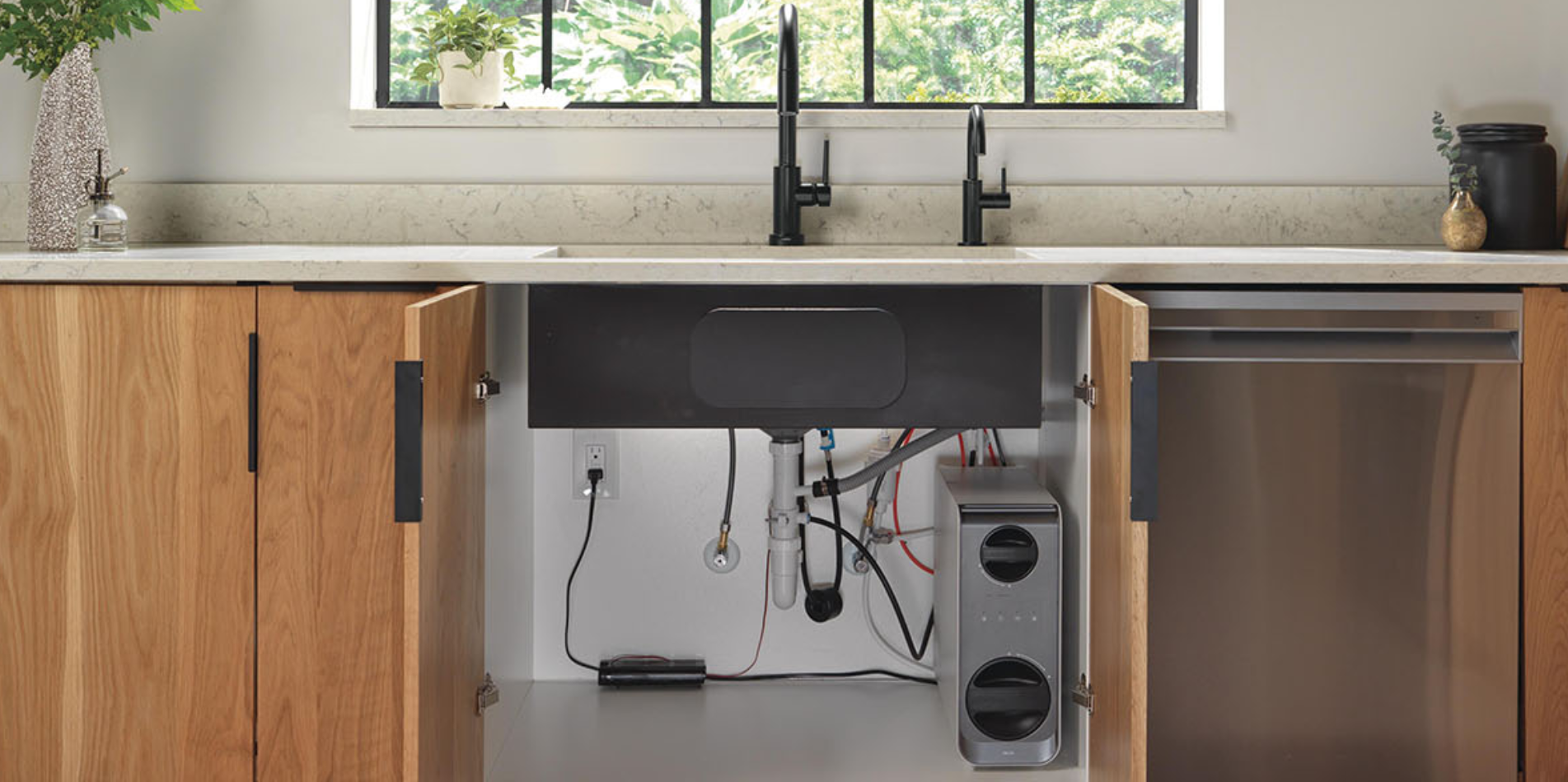 A modern kitchen with wood cabinets that are open revealing a compact Delta Clarifi Tankless Under-Sink Reverse Osmosis System under the sink