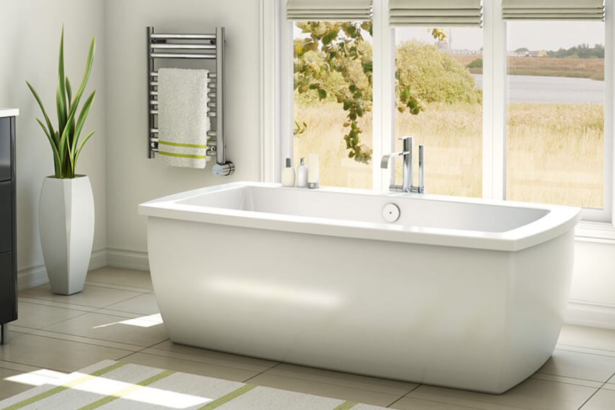 Mr. Steam Broadway Electric Towel Warmer A bathroom with a freestanding tub at the center and a Mr. Steam Broadway Electric Towel Warmer for warming towels mounted on the wall.