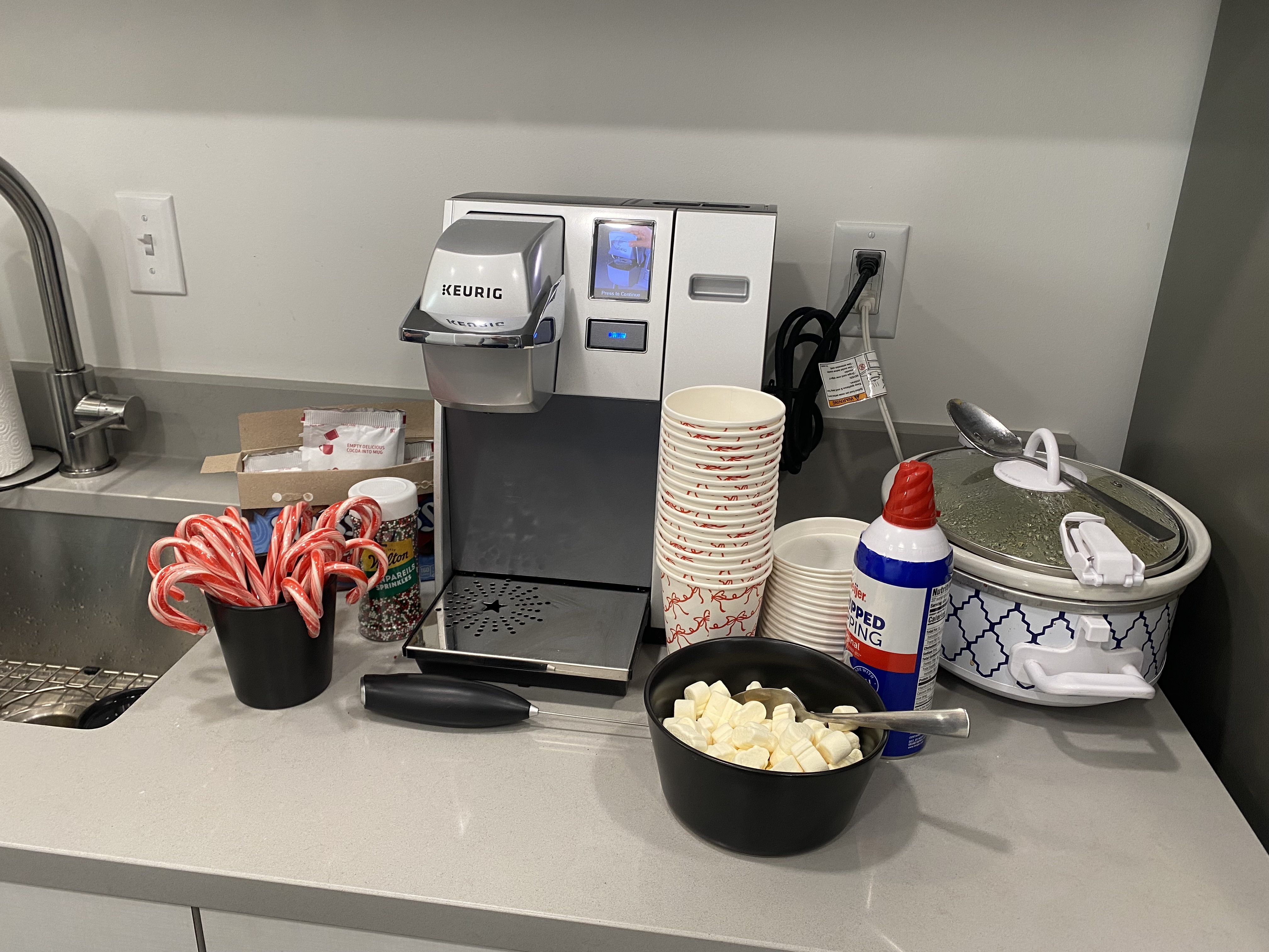 Hot chocolate bar with marshmallows, whipped cream, candy canes, and sprinkles