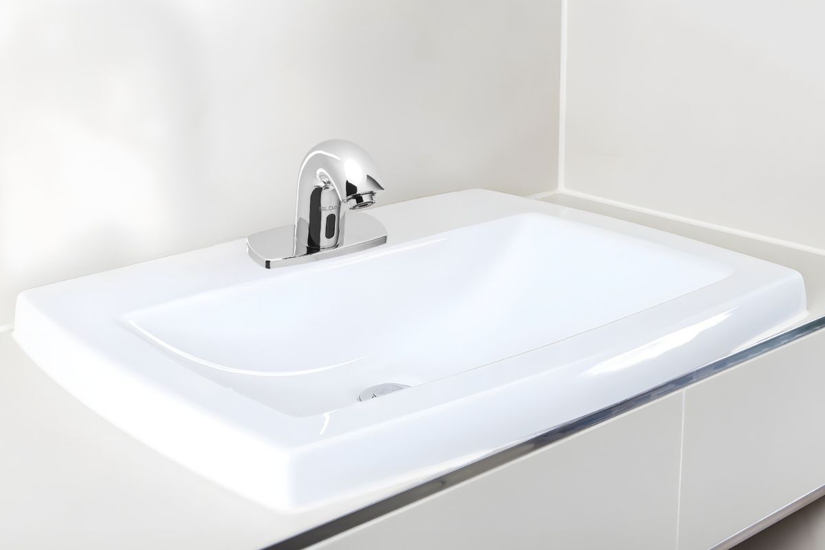 The chrome Sloan SF-2150 Battery-Powered Touchless Faucet&nbsp;installed over a white sink