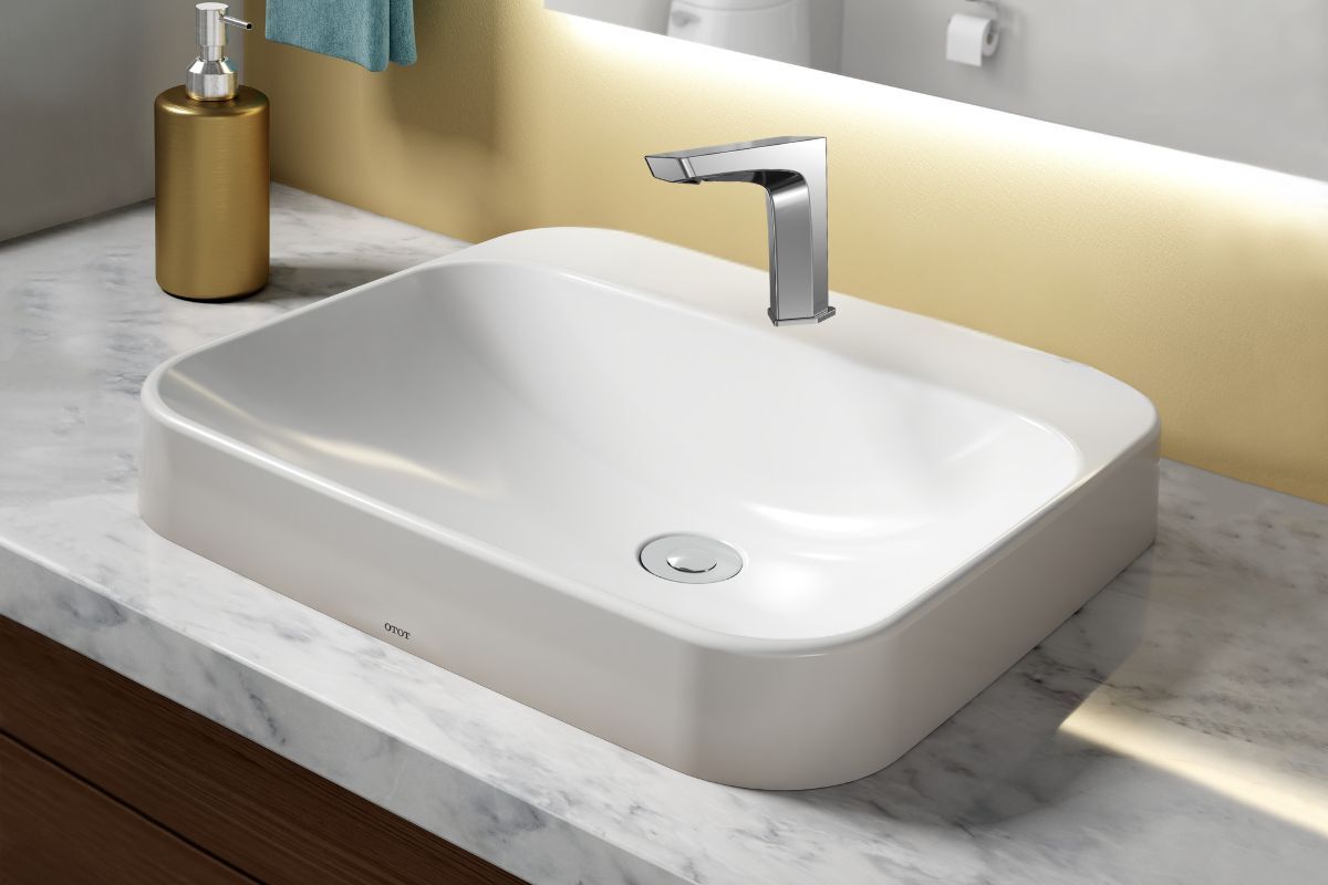 The brushed nickel TOTO GE&nbsp;EcoPower&nbsp;Touchless Faucet&nbsp;With&nbsp;Thermostatic Mixing Valve&nbsp;installed on a large white sink